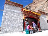 11 Chuku Nyenri Gompa Entrance With Tibetan Pilgrims On Mount Kailash Outer Kora Tibetan pilgrims circumambulate the Chuku (Nyenri) Gompa. Chuku Gompa was founded by Gotsangpa (1189-1258), a Kagyu disciple, and was the first Kailash Gompa to be rebuilt after the destruction of Cultural Revolution.